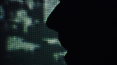 a silhouette of a person in front of a screen