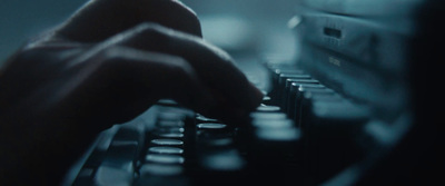 a close up of a person typing on a typewriter