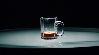 a glass mug with a liquid inside of it