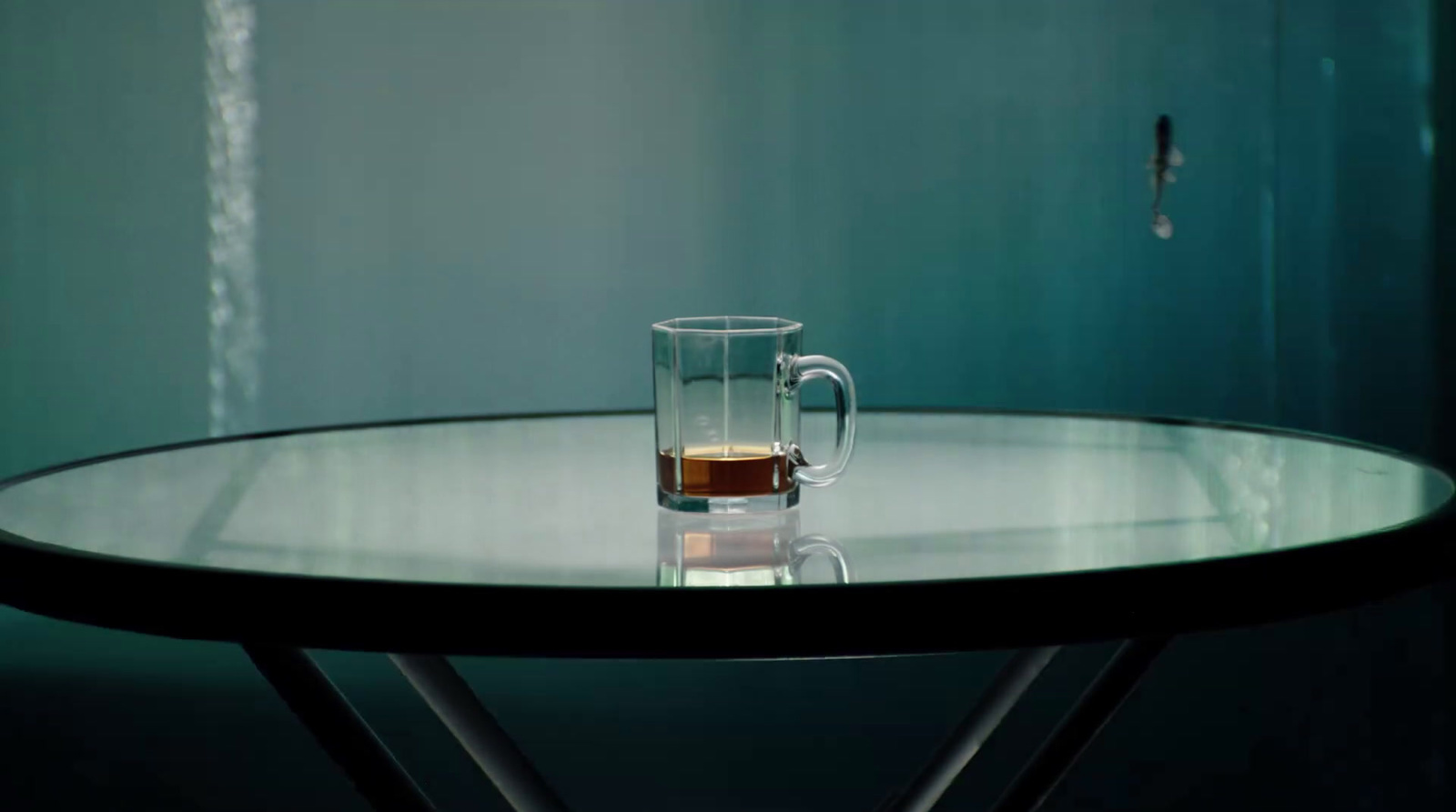 a glass of liquid sitting on top of a table