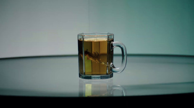 a glass mug of tea on a table