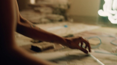 a woman is cutting a piece of paper with scissors