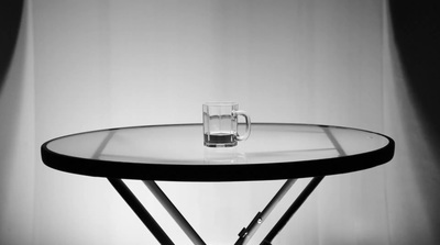 a glass of water sitting on top of a table