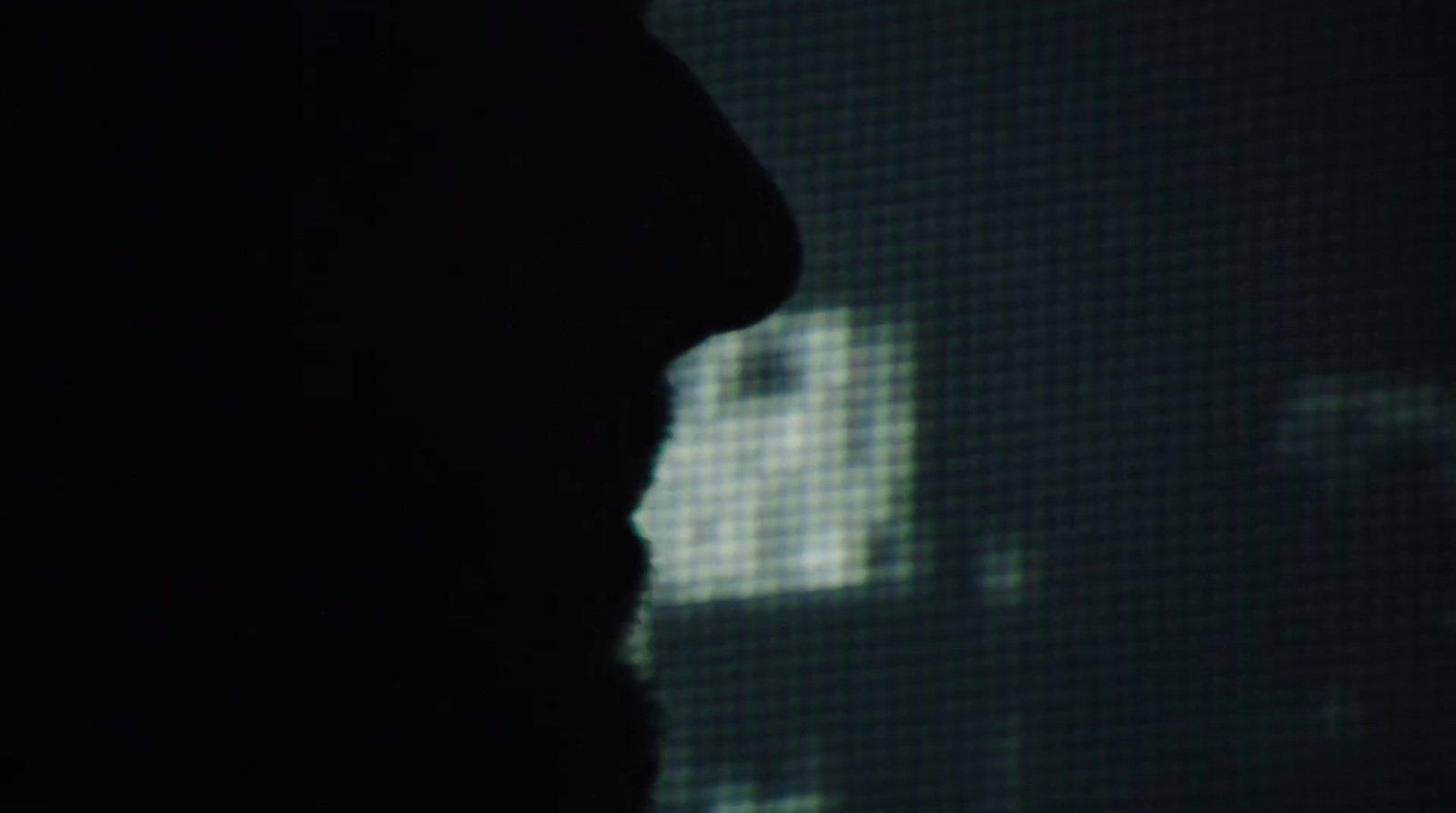 a silhouette of a man in a dark room