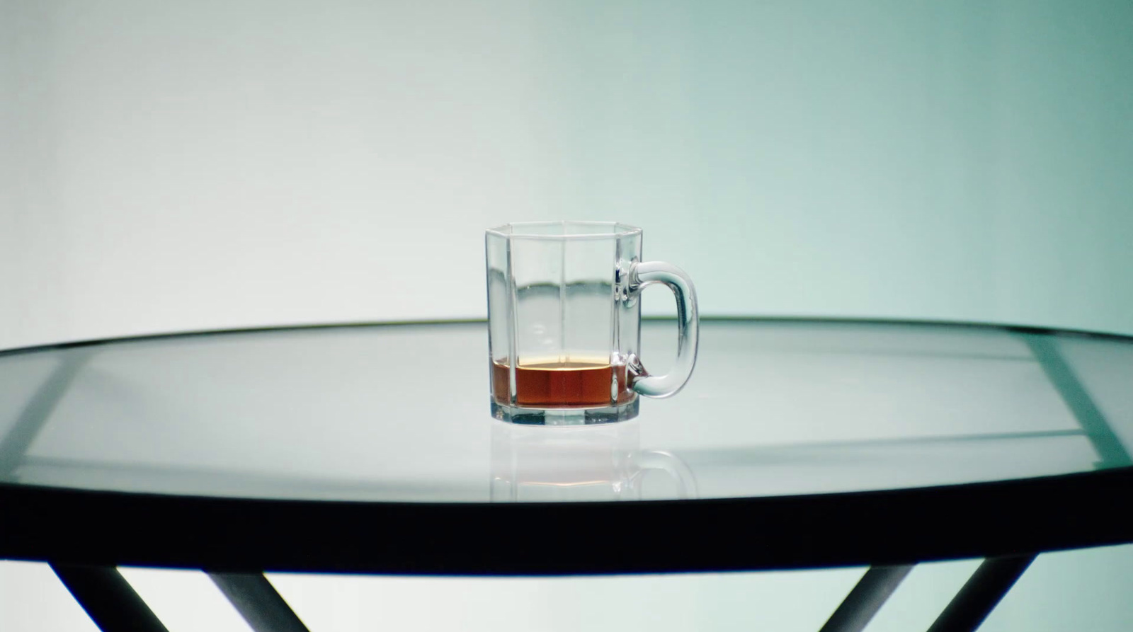 a glass of tea sitting on top of a table