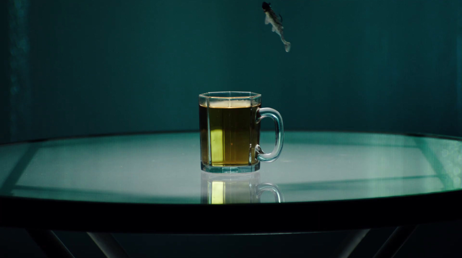 a glass of beer sitting on top of a table