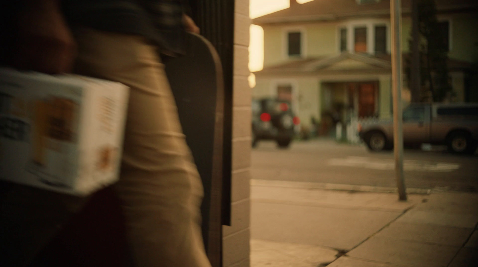 a person walking down a street holding a book