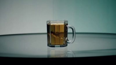 a glass of tea sitting on top of a table