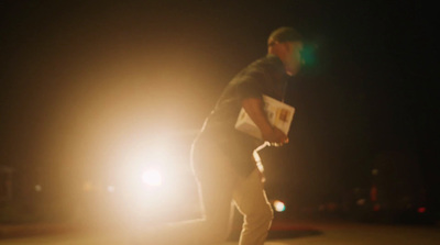 a man riding a skateboard down a street at night