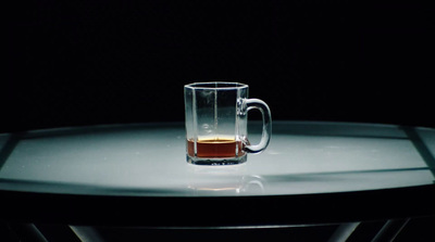 a glass of beer sitting on top of a table