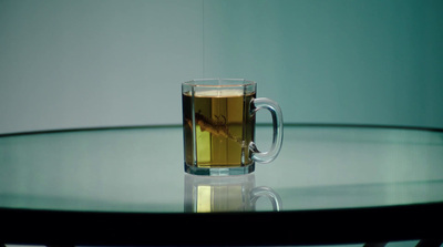 a glass of tea sitting on top of a table