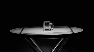 a glass of water sitting on top of a table