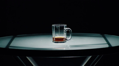 a glass of beer sitting on top of a table