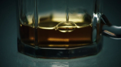 a close up of a glass with liquid in it