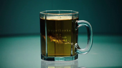 a glass mug with a liquid inside of it