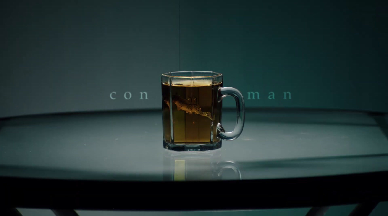 a glass of tea sitting on top of a table