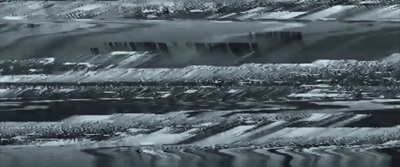 a black and white photo of a field of grass