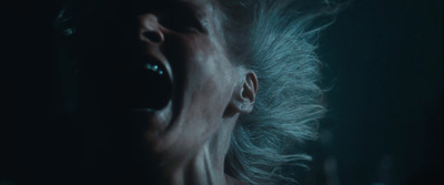 a woman with her mouth open in the dark