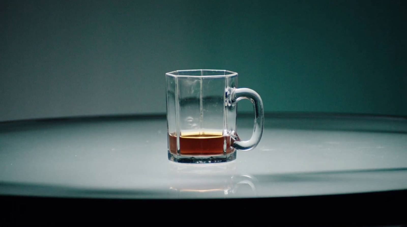 a glass cup with a liquid inside of it