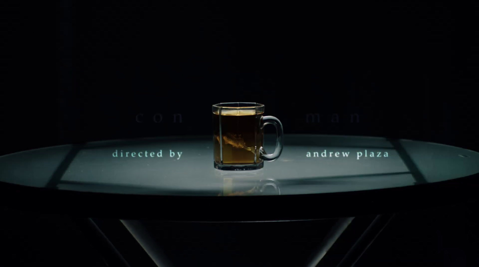 a glass of beer sitting on top of a table