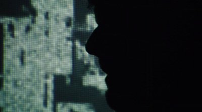 a silhouette of a person in front of a screen