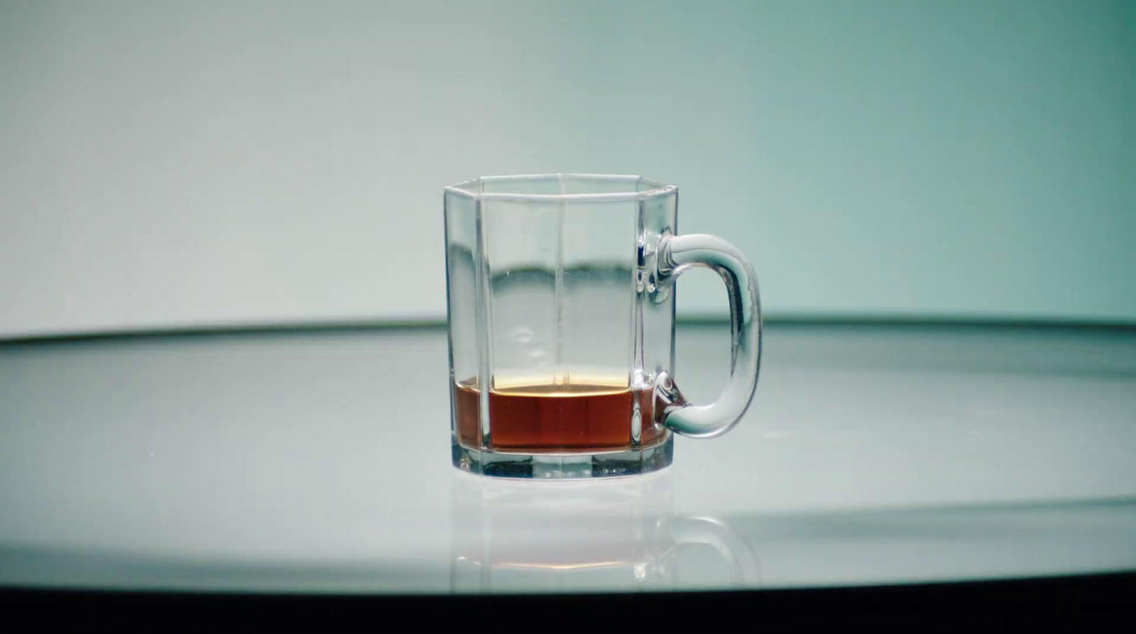 a glass of liquid sitting on top of a table