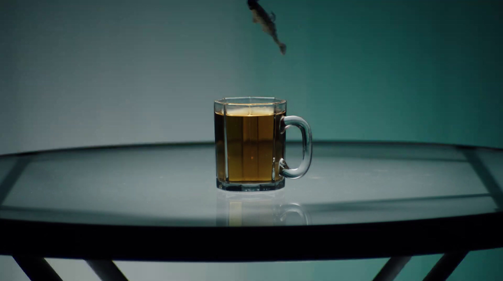 a glass of beer sitting on top of a table