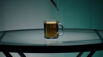 a glass of beer sitting on top of a table