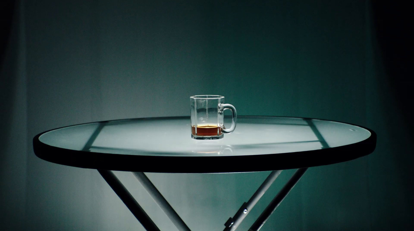 a glass of beer sitting on top of a table