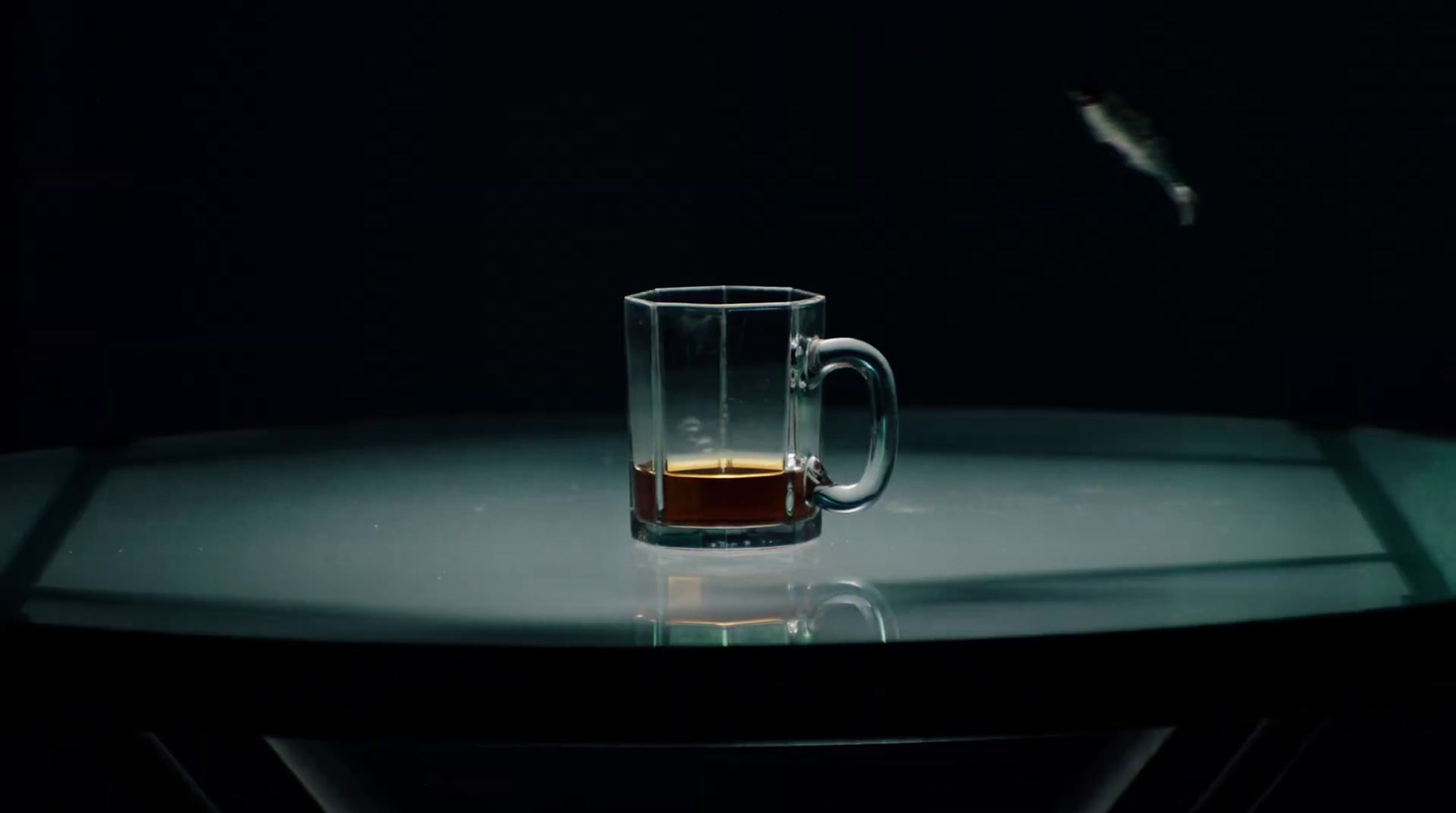 a glass of liquid sitting on top of a table