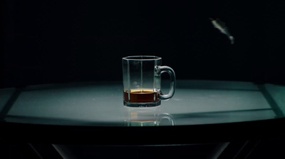 a glass of liquid sitting on top of a table