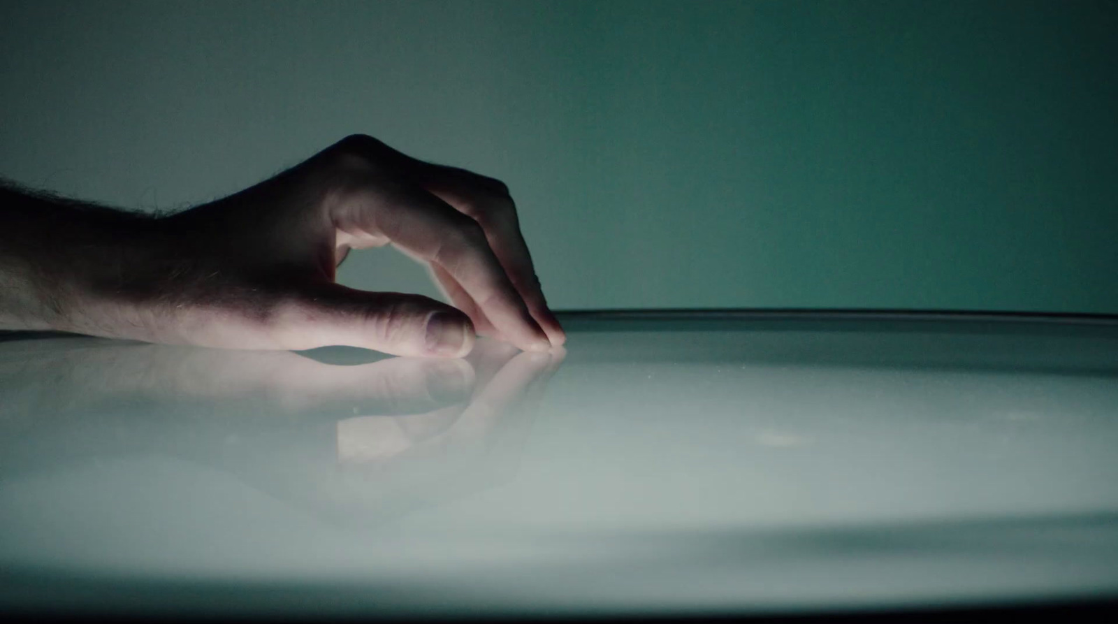 a person's hand on top of a table