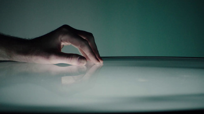 a person's hand on top of a table