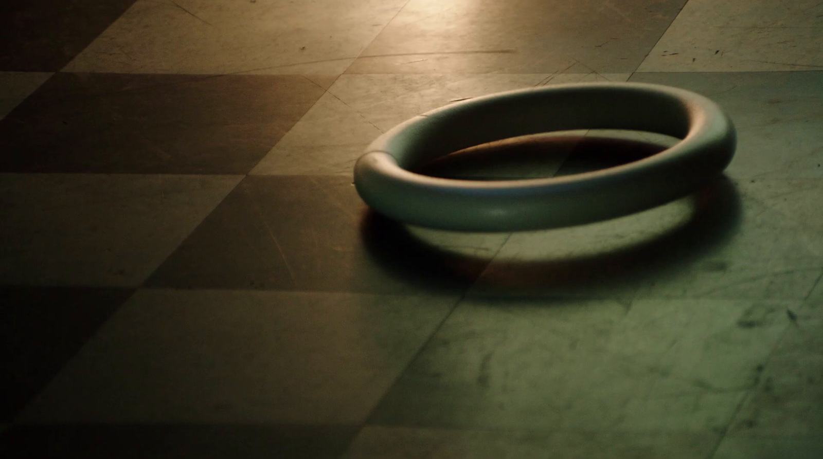 a close up of a white object on a tiled floor