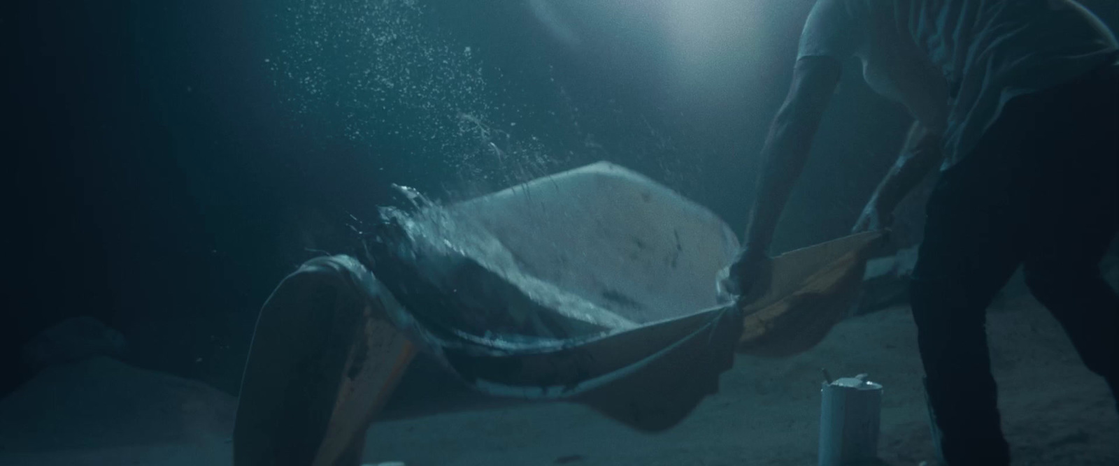 a man standing next to a trash can in the ocean