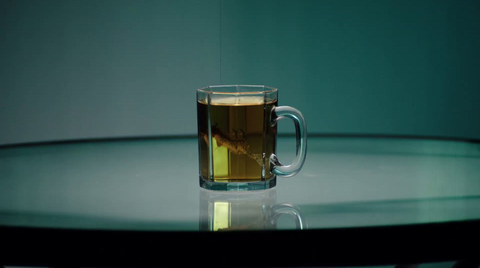 a glass of tea sitting on top of a table