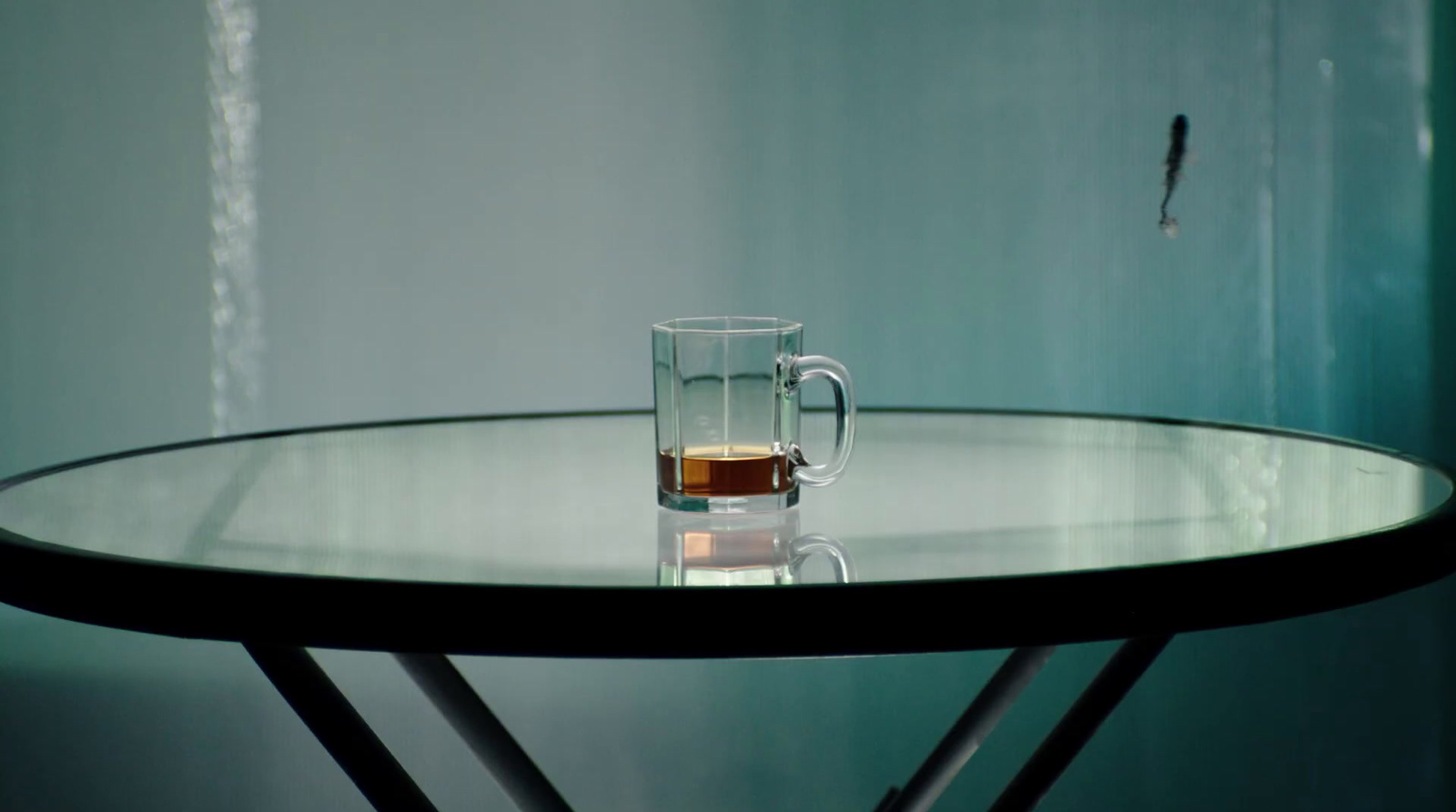 a glass of liquid sitting on top of a table