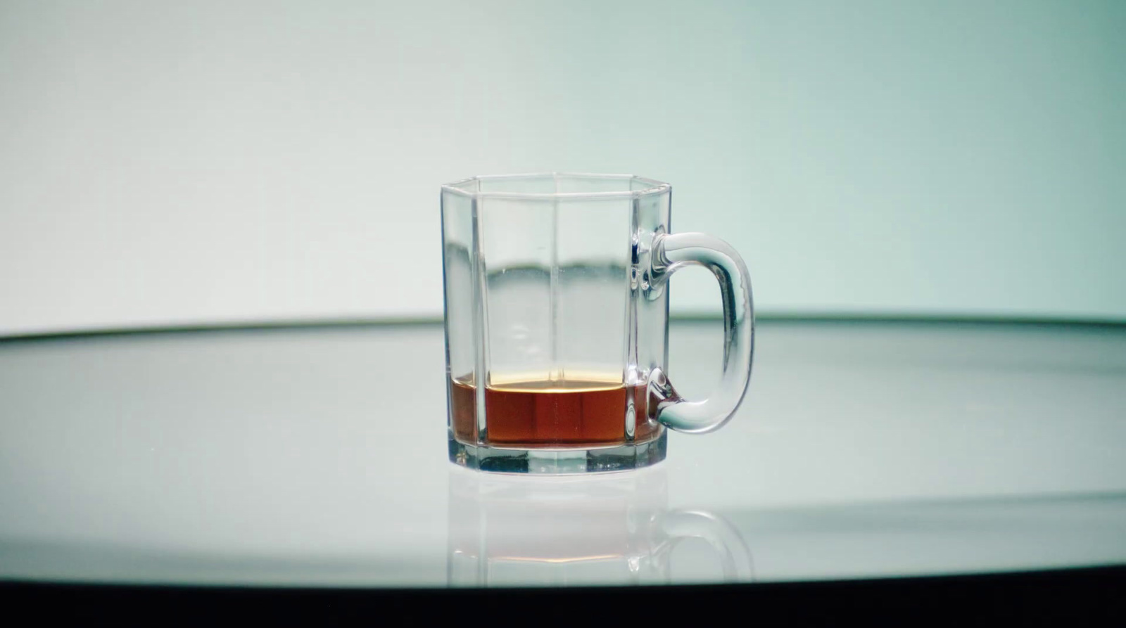 a glass mug with a liquid inside of it