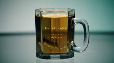 a glass mug filled with liquid on top of a table