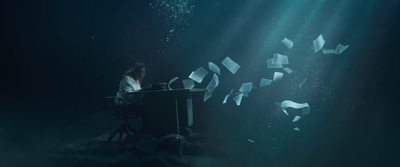 a woman sitting at a desk surrounded by papers floating in the air