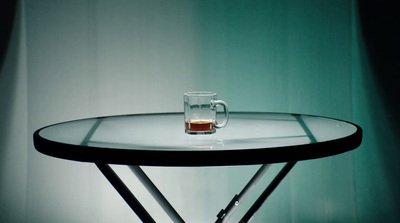 a glass of beer sitting on top of a table