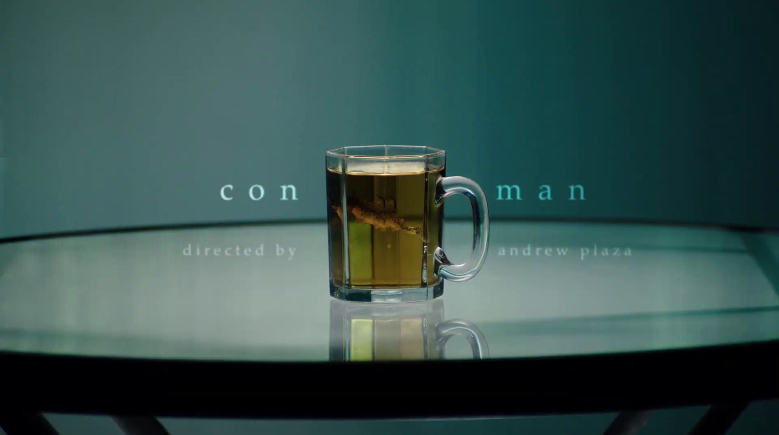 a glass of tea sitting on top of a table