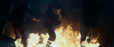 a group of people standing around a fire