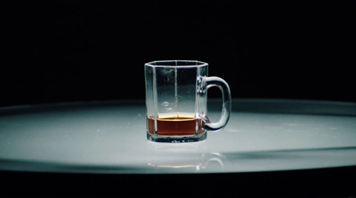 a glass mug with a liquid inside of it