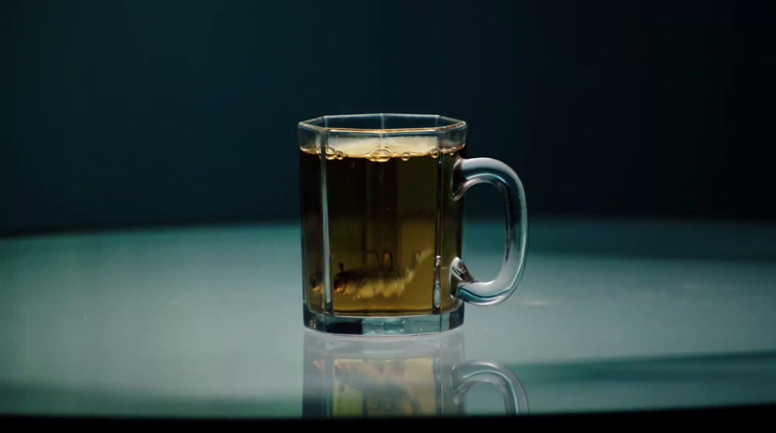 a glass of tea sitting on top of a table