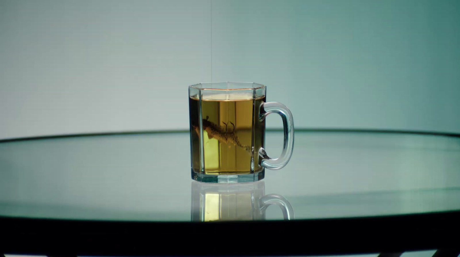 a glass of tea sitting on top of a table