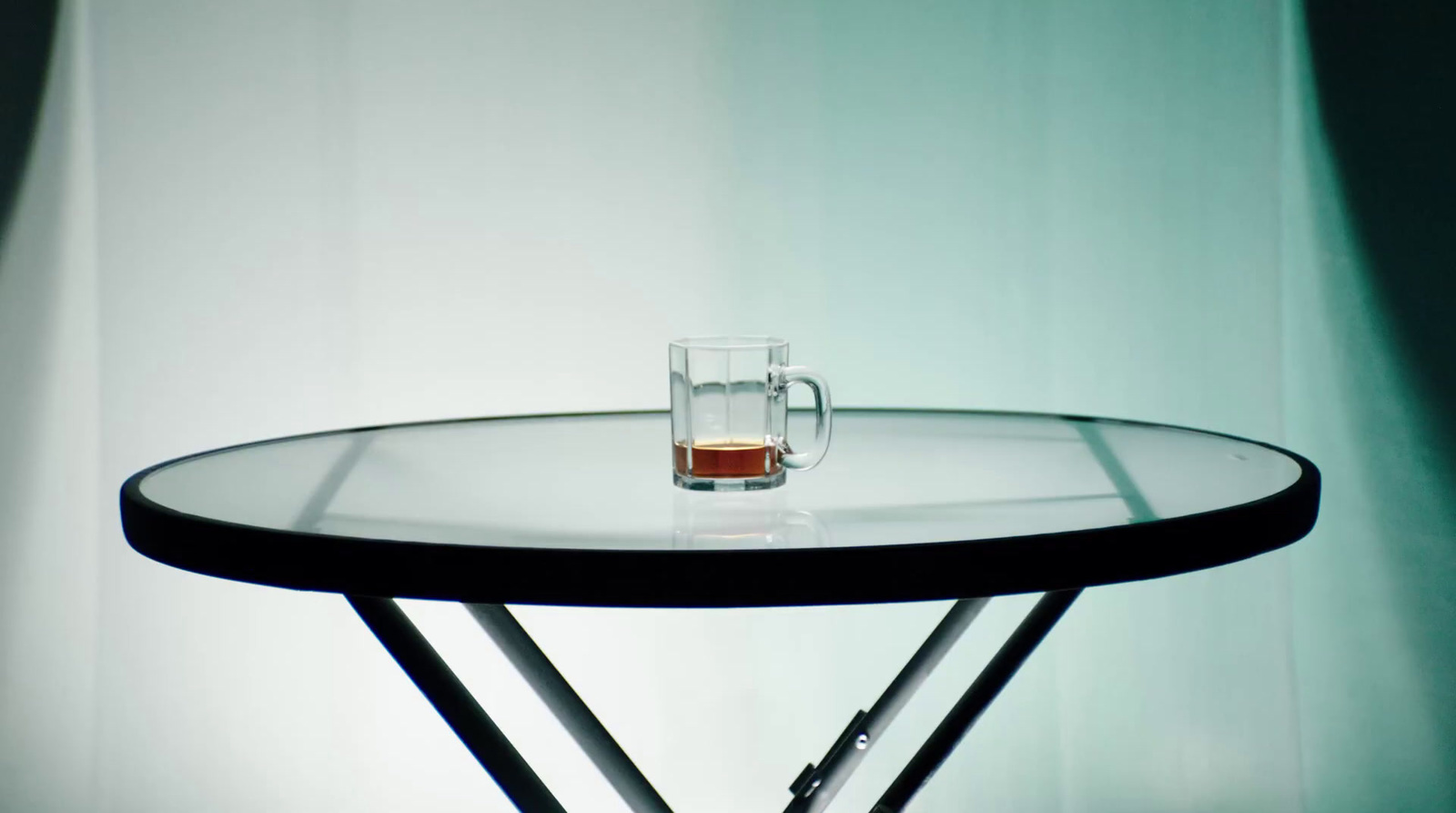 a glass of beer sitting on top of a table