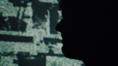 a silhouette of a man in front of a screen