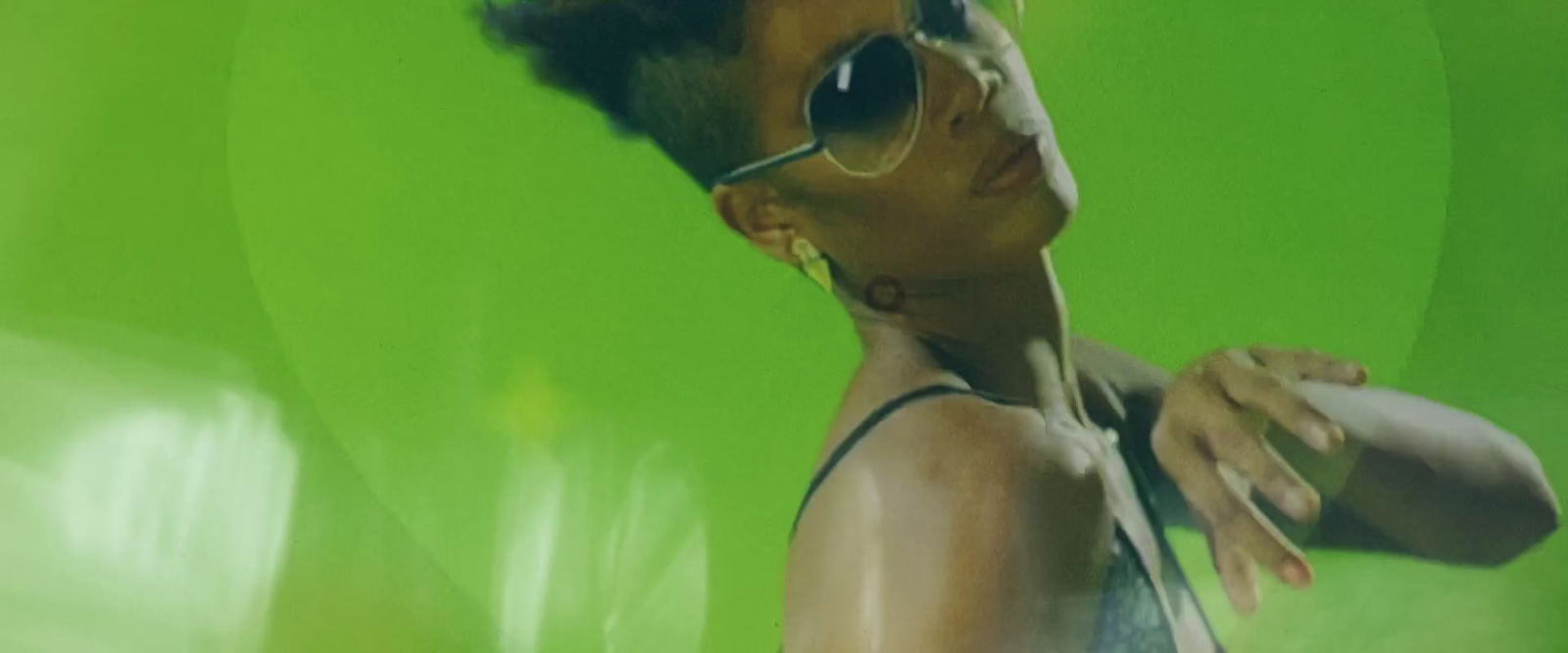 a woman wearing sunglasses and a tank top