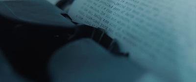 a close up of a book with a typewriter in the background